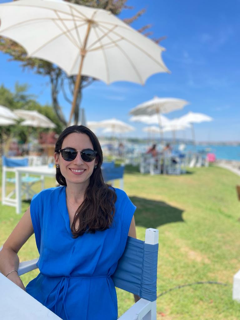 The coach Laura Maldonado sitting in a sunny garden under an umbrella