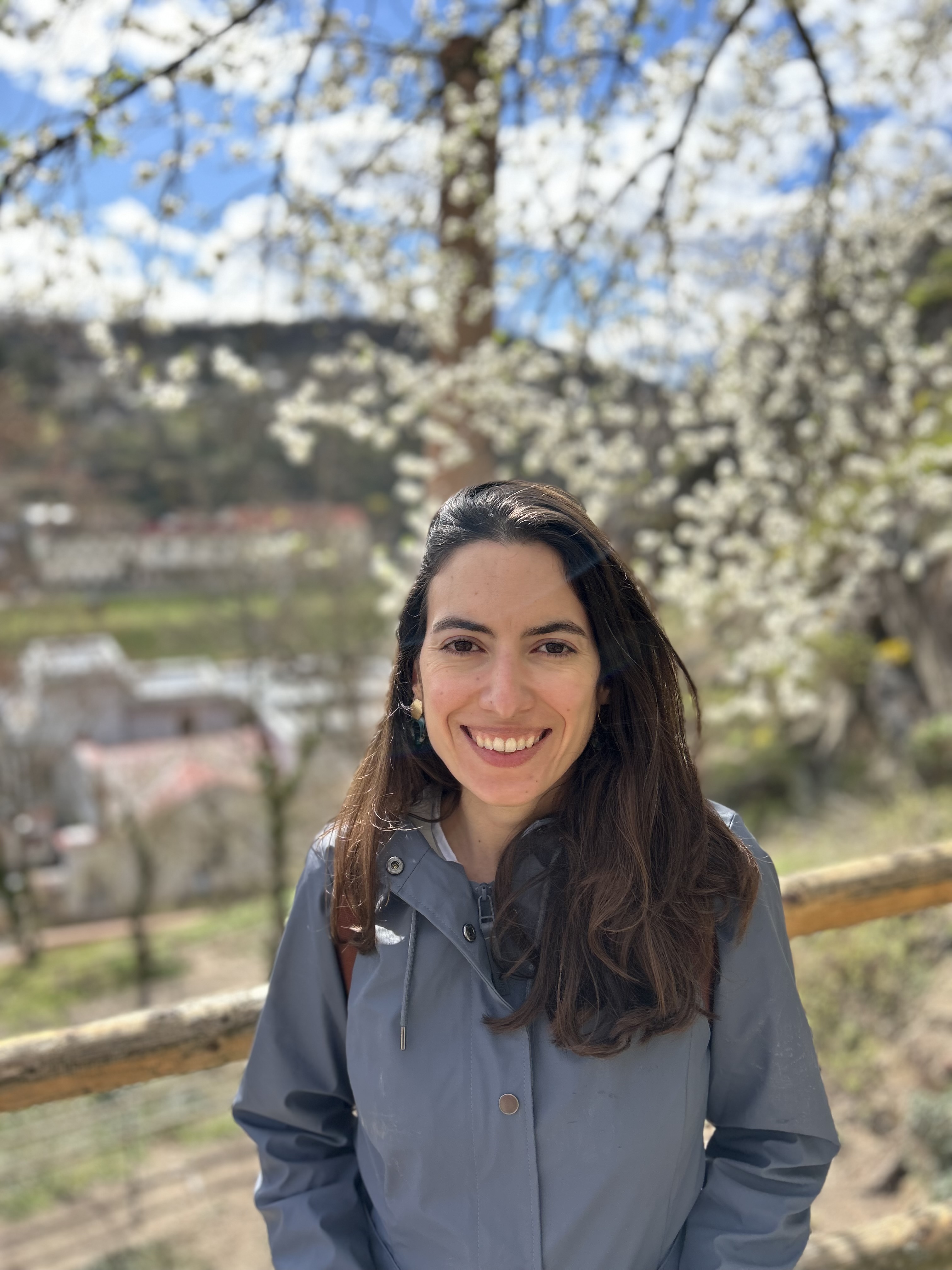 Coach Laura Maldonado standing in front of a blooming tree