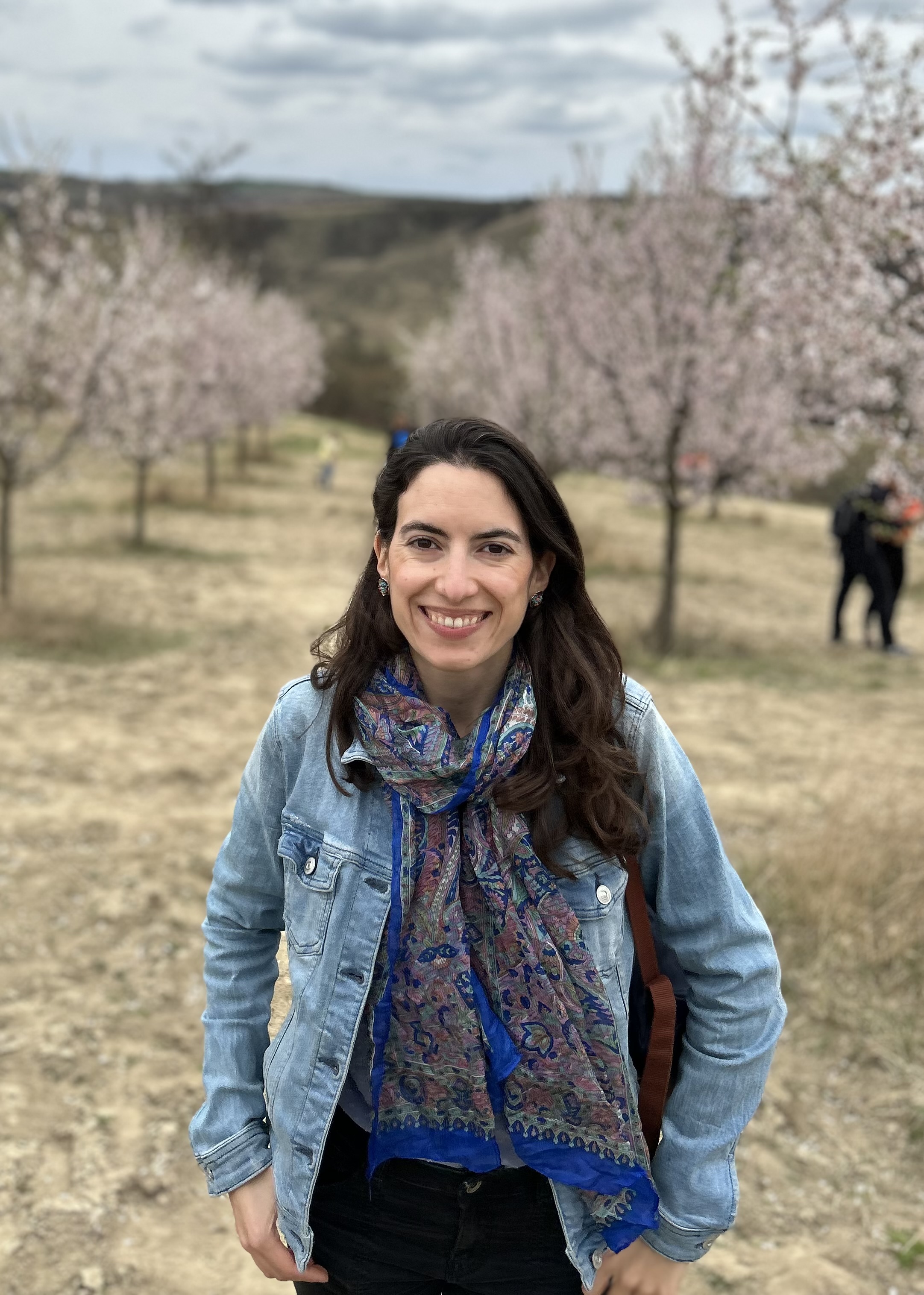 Coach Laura Maldonado standing in front of a blooming tree